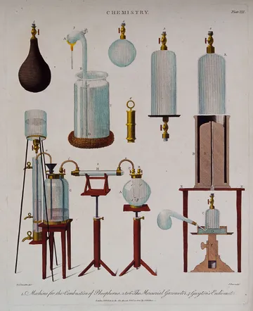 Glass and metal chemical apparatus arranged on a table, coloured engraving.